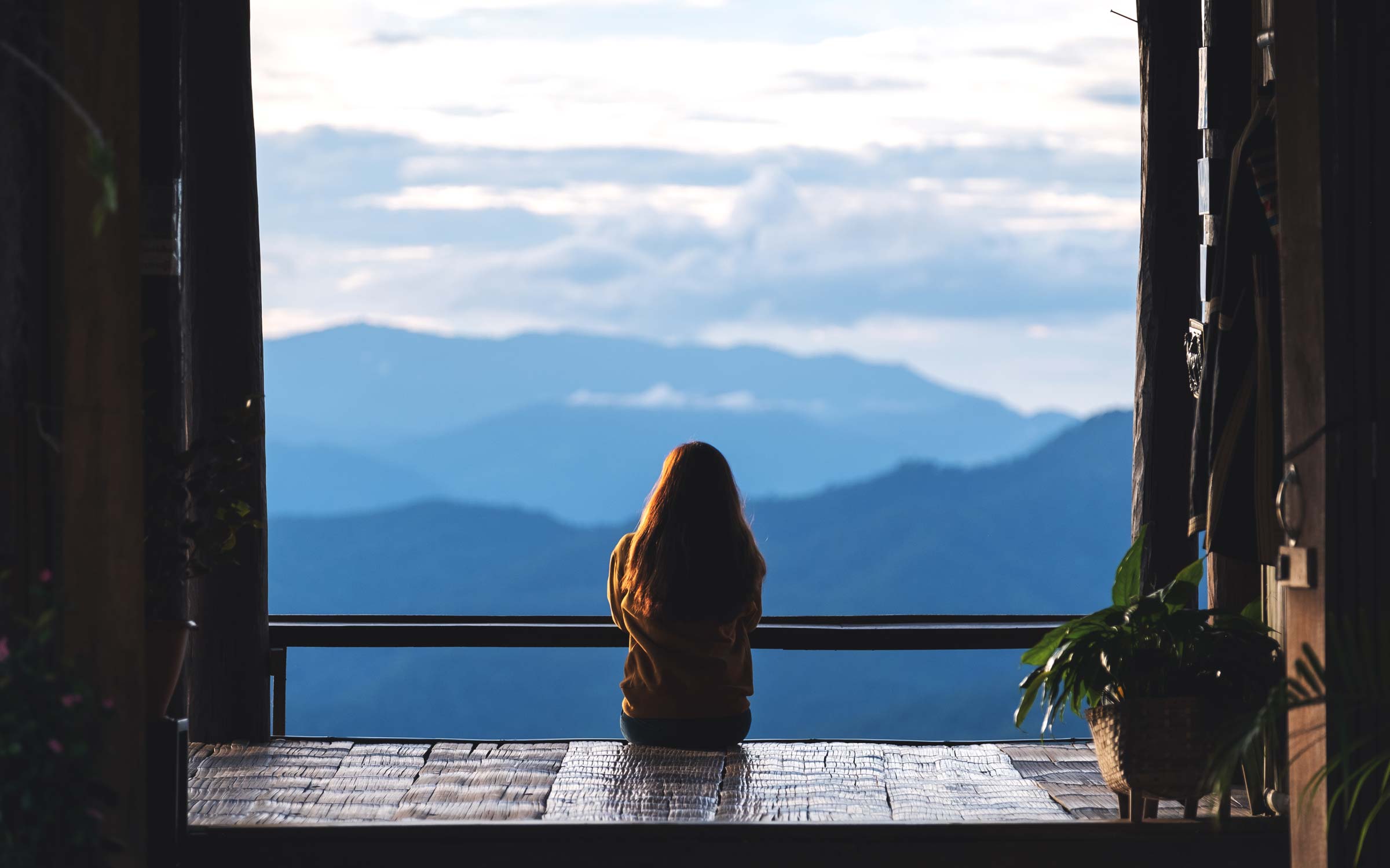 a-female-traveler-sitting-and-looking-at-a-beautif-2022-12-16-05-13-36-utc.jpg